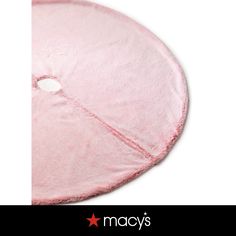 a pink round rug with the word macy's on it and a red star