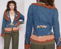 "Vintage 90s women's boho denim blazer with floral appliques, beading, and ruffled chiffon trim on the shoulders and hem. It closes with a rosette loop closure at the front of the waist.  Measurements and Condition: Fits like: Labeled small (fits oversized) Fabric: Cotton denim with chiffon trim and lining Brand: Sara Studio, made in India Condition: Very good, with light general wear, and a 1/2\" tear in the waist loop closure. Length: 25.5\" Chest: 39\" Waist: 35\" Shoulders (seam to seam): 15 Fitted Spring Outerwear With Ruffles, Fitted Bohemian Denim Outerwear, Fitted Denim Outerwear With Ruffles, Beaded Outerwear For Spring Festival, Vintage Beaded Outerwear For Spring, Spring Vintage Beaded Outerwear, Beaded Vintage Outerwear For Spring, Fitted Beaded Outerwear For Fall, Embellished Blazer