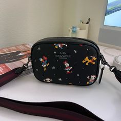 Printed Coated Canvas And Smooth Leather Two Credit Card Slots Inside Multifunction Pocket Zip Closure, Fabric Lining Outside Open Pocket Detachable Strap With 22 3/4" Drop For Shoulder Or Crossbody Wear 7 1/2" (L) X 5 1/4" (H) X 2 1/4" (W) Disney X Coach Disney Style No. Cn027 Trendy Rectangular Bags For Disney Trips, Coach Disney Bags, Coach Pouch Shoulder Bag With Zipper Pocket, Coach Black Bag With Zipper Pouch, Coach Disney, Coach Shoulder Bag With Removable Pouch For On-the-go, Disney Bag, Holiday Prints, Coach Bags