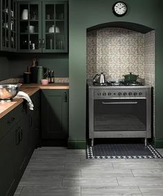 a kitchen with green cabinets and an oven