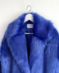 "Royal Blue, Indigo Blue Oversize Fur Coat. Luxury, fluffy fabric, very soft. 100% polyester. Handmade made in London, UK.  Oversize style. Big collar. Long sleeves. Metal snap buttons (invisible) Two side pockets. Lenght 82cm - 1cm) Handmade in UK.  Model wears size S.  HOW TO CHOOSE A SIZE ?   Using a measuring tape, measure your bust, waist and hips (widest part) and compere with size chart.  SIZE CHART: (CM) B: Bust  H: Hips  XS - B: 83-88 cm  H: 90-95 cm  S - B: 88-93 cm H: 95-100 cm  M - B: 93-98 cm H: 100-105 L - B: 103-108 cm  H: 105-110 cm XL - B: 108-113 cm H: 110-115 cm CARE INSTRUCTIONS: Dry clean only, do not wash, do not iron, do not bleach.  Please message me before purchasing so I can check availability. If you wish this fur in any other colour, shorter or longer \"send mes Luxury Fur Coat, Grammy Performance, Oversized Fur Coat, Blue Fur Coat, Blue Faux Fur Coat, Festival Coats, Fringe Coats, Fluffy Fabric, Oversize Style