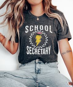 Embrace a vintage vibe with our Funny School Secretary Shirt, perfect for the new school year. This Back To School Tshirt is a Cute T-shirt Gift for School Secretary, blending classic style with modern comfort. Ideal for school receptionists, this Admin Squad Tee is a thoughtful way to show appreciation for their hard work and dedication. Product Description: ⇝ Bella and Canvas Brand Shirts ⇝ Unisex Adult Sizing ⇝ Rolled Sleeves in pictures are for styling purposes only ⇝ Props used in photos fo School Spirit T-shirt With Graphic Design, School Spirit T-shirt For School Events, School Spirit T-shirt With Text Print For School Events, Back To School Graphic Tee With Screen Print, School Slogan T-shirt Short Sleeve, School Slogan T-shirt With Short Sleeves, Short Sleeve Slogan T-shirt For School, Graphic Tee T-shirt With Text Print For School, Graphic Print Short Sleeve T-shirt For School Events