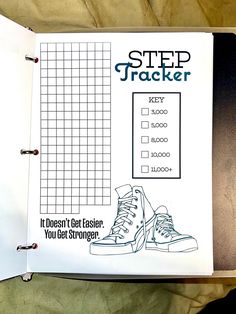 a notebook with an image of a pair of shoes on it and the words step tracker