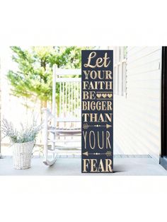 a wooden sign that says let your health be bigger than your fear on the front porch