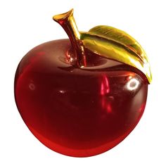 a shiny red apple with a gold leaf on top