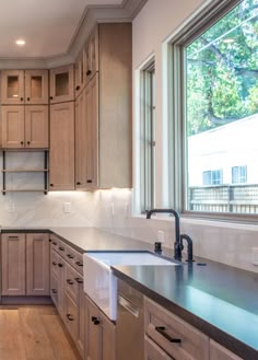 a kitchen with wooden cabinets and stainless steel appliances