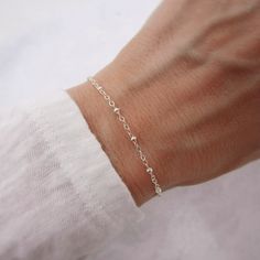 Please read sizing info below. This dainty (but sturdy) bracelet is made entirely of 925 sterling silver so it makes a lasting keepsake. Made with a cable chain that features beaded detailing and secures with an easy-to-use lobster clasp. Comes in a little gift box. SIZING - IMPORTANT: To determine bracelet size, measure snugly around your wrist and add 1/2 inch. This is available with an optional 1 inch extension chain added. Note, this will be added to whatever bracelet length you select. For Silver Permanent Bracelet, Sterling Silver Bracelets With Tiny Beads For Everyday, Everyday Sterling Silver Bracelets With Tiny Beads, Sterling Silver Beaded Bracelets With Silver Clasp For Everyday, Sterling Silver Beaded Bracelets With Tiny Beads, Classic Sterling Silver Bracelet With Extender As Gift, Everyday Silver Jewelry With Tiny Beads, Sterling Silver Charm Bracelet With Round Beads For Everyday, Adjustable Dainty Sterling Silver Hypoallergenic Bracelet