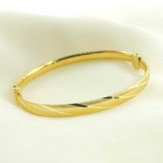 14K Solid Gold Matte Textured Bangle Bracelet HIGH QUALITY BANGLES This modern and on-trend design is crafted from genuine 14k solid gold Length: 65mm Width: 57mm Circumference: 21cm (8.3 inches) Weight:7.55g Thickness:3mm Size:6mm Metal: 14k Solid Gold Purity: 14K (Stamped for Authenticity)  Processing time: 1-2 business days FAST SHIPPING It has a stamped ITALY. Gold Jewelry Store NY sells only authentic solid 14K Gold. We do not sell gold plated or gold-filled jewelry. This is a delicate bang Adjustable Round Heirloom Gold Bracelet, Adjustable Heirloom Gold Bracelet, Yellow Gold Bangle Bracelet With Gold Clasp, Hallmarked 14k Gold Bangle Bracelet, Adjustable 14k Gold Bangle With 17 Jewels, Formal 14k Gold Hoop Bracelet, Gold Hoop Bracelets In 14k, Adjustable Oval Yellow Gold Bangle, Adjustable Yellow Gold Hallmarked Bracelet