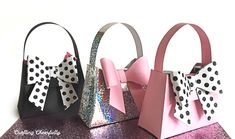 three small purses with bows on them