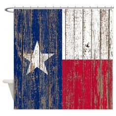 a shower curtain with the texas flag painted on it's wood paneled wall