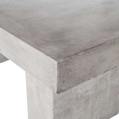 a concrete table sitting on top of a white sheet