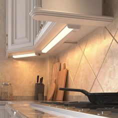 a stove top oven sitting inside of a kitchen next to a counter with cutting boards on it