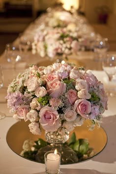 the table is set with flowers and wine glasses for guests to sit down at it