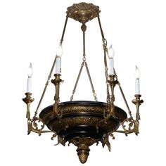 an antique chandelier with five candles hanging from the center and four lights on each side