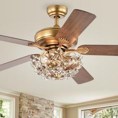 a chandelier hanging from a ceiling fan in a living room