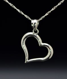 The Varenna Ladies Contemporary 14K White Gold Heart Necklace. Dangling from a 16 inch chain is a 0.75 inch white gold heart pendant. The perfect gift for that special someone. Each piece has been hand selected and meticulously identified and graded by a Graduate Gemologist who has been awarded a degree by the Gemological Institute of America (GIA). Please visit our Shop's About Page or our website for more information about our jewelry. Sizing for all rings is an additional charge and will be d Elegant Sterling Silver Heart Necklace With Polished Finish, Formal Heart Charm Jewelry With Heart Pendant, Formal Heart Pendant Jewelry With Heart Charm, Elegant Sterling Silver Hallmarked Heart Necklace, Formal Sterling Silver Heart Cut Necklace, Sterling Silver Heart Cut Necklace For Formal Occasions, Classic White Gold Heart Pendant Necklace, Formal Polished Heart Pendant Necklace, Classic White Gold Double Heart Necklace