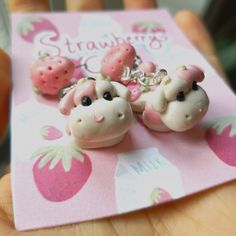 there are two little sheep earrings on the card