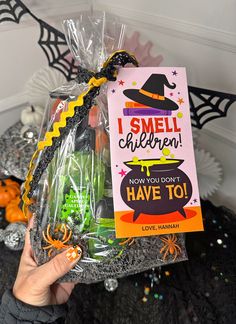 someone is holding up a halloween gift bag