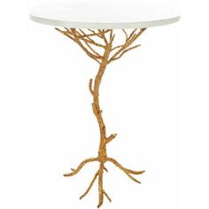 a white table with gold branches on the side and a round top that has an oval base