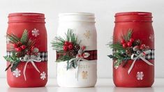 three mason jars decorated with christmas decorations