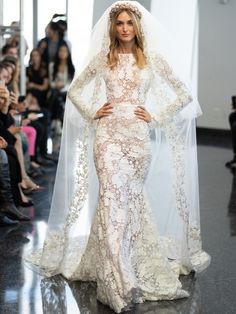 a woman in a wedding dress with a veil on her head