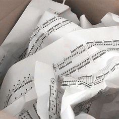 an open box with sheet music on it and paper wrapping around the inside of it