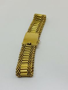 "This is a beautiful, vintage 14K yellow gold bracelet. Material(s) 14K yellow gold Measurements: This bracelet measures 7 inches in length and 14.3 millimeters in width. Weight: 24.6 grams Markings: \"14K\" If you have any questions about this bracelet, please do not hesitate to contact us! ♥" Antique Gold Bracelet Stamped 14k, Antique 14k Stamped Gold Bracelet, Classic Gold Band Bracelet, Gold Jubilee Bracelet Band, Formal Gold-tone Bracelet With Gold Clasp, Rectangular Gold Bracelet With 17 Jewels, Heirloom Gold Jubilee Bracelet, Vintage 14k Gold Bracelet For Anniversary, Heirloom 14k Gold Bracelet