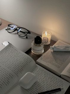 an open book and some glasses on a desk