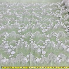 This exquisite Beaded 3D Floral Lace Fabric Embroidered on 100% Polyester Net Mesh is the perfect choice for creating unique, couture-level designs. Soft yet durable, this high quality fabric is beautifully crafted, adding texture and texture and dimension to your creations. From wedding dresses and bridal gowns to special occasion wear and dancewear, this fabric will make any design stand out. With its beading, pearls, and sequined accents, it will provide the perfect finishing touch. Shopping Elegant White Embroidered Fabric With 3d Embroidery, Elegant White Fabric With 3d Embroidery, Elegant White 3d Embroidered Fabric, White Embroidered Fabric With Pearl Detail, White Embroidered Fitted Fabric, White Embroidered Party Fabric, Party Embroidered White Fabric, Fitted Lace Fabric With 3d Embroidery, White Embroidered Fabric With Appliques For Party