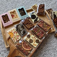 assorted cookies and treats laid out on a wooden tray