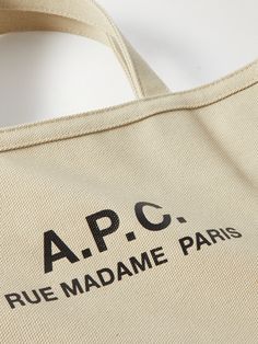 a tote bag with the words, apc rue madame paris on it