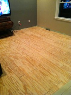 a room with hard wood flooring and a flat screen tv