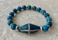 Teal Blue French Cross Focal Bead with 8mm Blue Crazy Lace Agate Gemstones Stretch Bracelet These Java glass beads are modeled after traditional French cross trade beads. French cross beads were originally produced in Venice and traded throughout Africa. Blue Polished Beads Spiritual Stretch Bracelet, Spiritual Blue Stretch Bracelet With Polished Beads, Blue Spiritual Stretch Bracelet With Large Beads, Spiritual Blue Stretch Bracelet With Large Beads, Blue Beaded Bracelets For Healing With Large Beads, Blue Agate Stretch Bracelet With Round Beads, Cross Beads, Blue French, Trade Beads