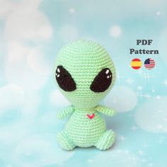 a crocheted green alien sitting on top of a blue background with the text, free pattern