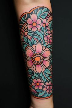 a woman's arm with an ornate flower tattoo on the left side of her arm