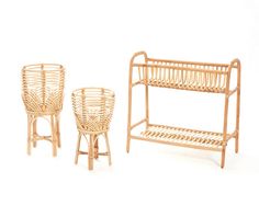 three wicker chairs and a baby crib on a white background