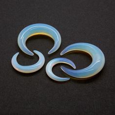 two blue and yellow swirls sitting on top of a black surface