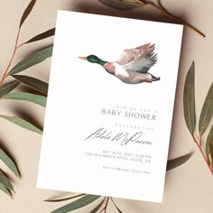 a baby shower card with a watercolor duck on the front and green leaves in the back