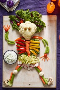 the food is made to look like a human body, with vegetables and veggies