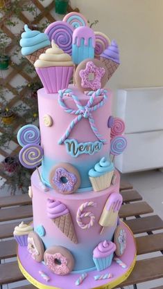 a three tiered cake decorated with donuts and icing