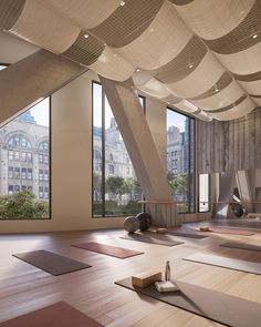 a yoga studio with large windows overlooking the city