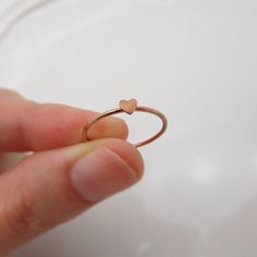 REAL ROSE GOLD FILLED 14/20 I love how this adorable little heart ring turned out and am so happy to share it with you! The dainty band features a polished surface, accented with a tiny heart that measures approximately 3-4 mm. The lovely rose gold color is perfect for this minimalist piece. Great for stacking up with other rings but also beautiful when worn alone. STERLING SILVER, GOLD, OR ROSE GOLD: This listing is for a ring in rose gold filled. However, I can also make these in yellow gold f Stackable Birthstone Rings, Dainty Band, Mom Ring, Real Rose, Gold Alloys, Ring Rose Gold, Tiny Heart, Ring Dainty, Rose Gold Color