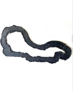 a piece of paper that is shaped like a long, curved road with black paint on it