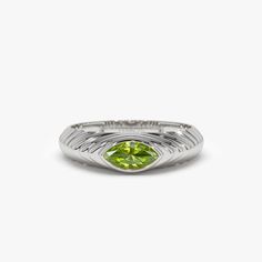 Made to Order Gold Kt: 14K Solid Gold (also available in 18K) Available Gold Colors: Rose Gold, Yellow Gold, White Gold Marquise Peridot: 1 pc 7 x 3.5 MM Peridot Carat Weight: 0.43 ctw The August birthstone, a brilliant 7x3.5 MM marquise cut peridot, is set in this 14k Gold step beveled ring. The peridot gemstone gives the ring a splash of color and a modern shape that makes it ideal for daily use. The step-beveled pattern gives the ring depth, and the 14k Gold adds a touch of elegance. Anyone w Peridot Ring For Men, Yellow Gold Peridot Ring, Peridot Signet Ring, Laos Jewelry, Peridot Rings With Polished Finish, Lime Green Peridot Rings Fine Jewelry, Local Jewelry, Peridot Gemstone, Wrap Rings