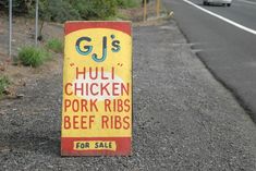 a sign on the side of the road that says huli chicken pork ribs beef ribs for sale