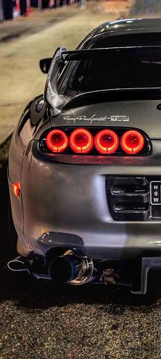 the rear end of a silver sports car