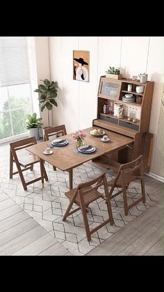 a wooden table with chairs and plates on it