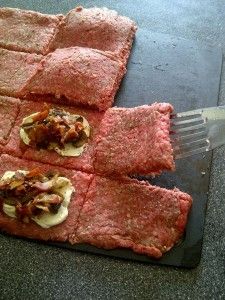 some food that is on top of a cutting board with a spatula in it