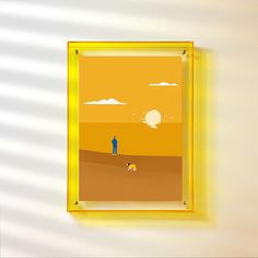 a yellow frame hanging on the wall with a painting of a man and his dog