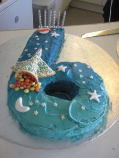 a birthday cake with blue frosting and stars on it